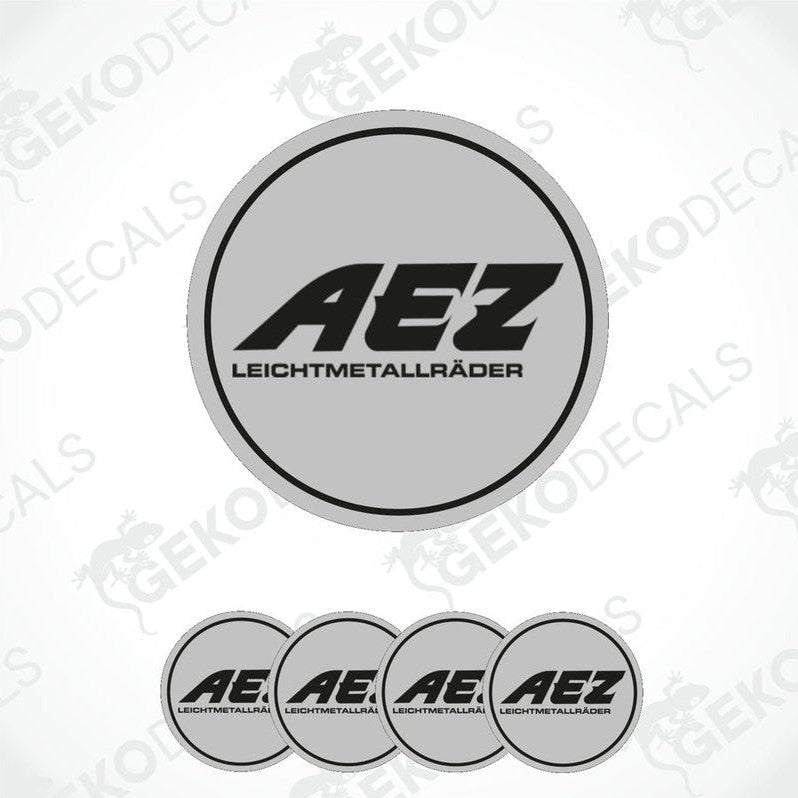 A set of four grey vinyl stickers with the AEZ brand logo, designed for use as car decals.