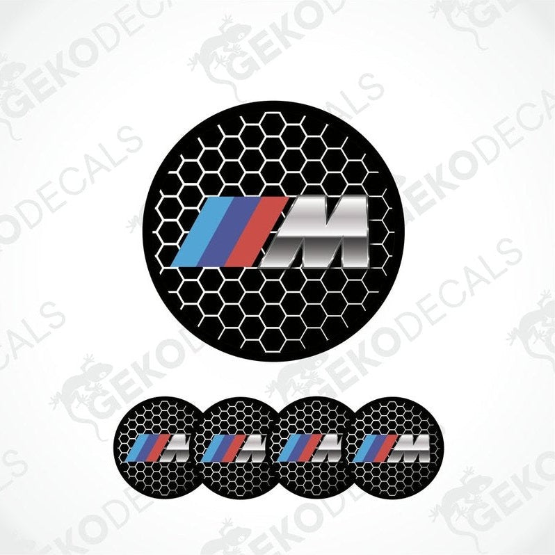 A set of four vinyl decals with a polyurethane coating, featuring the BMW M logo in black, red, blue, and silver colors on a hexagonal pattern background.