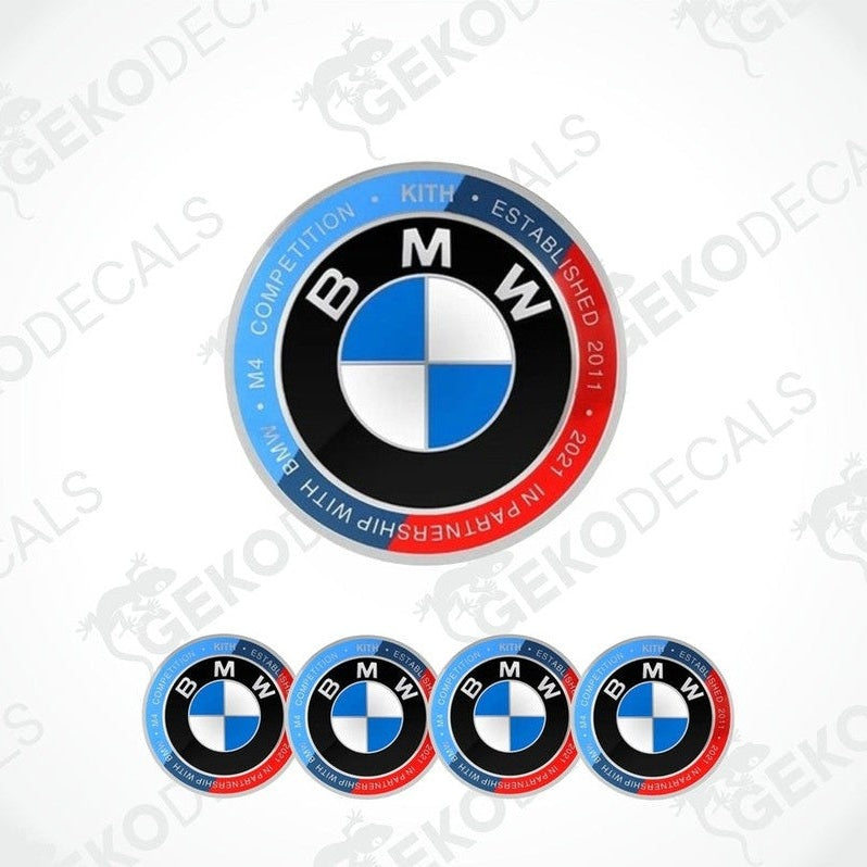 Set of vinyl decals with polyurethane coating for BMW M 4 COMPETITION, including one large emblem decal and four smaller ones for wheels.