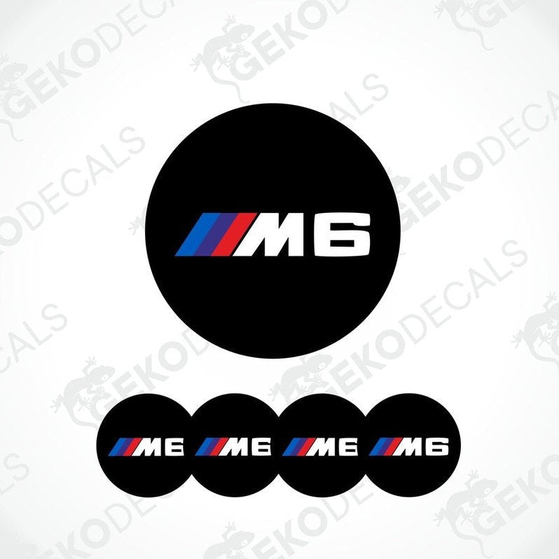 A set of four black vinyl stickers with the BMW M6 logo, designed for use on car wheels.