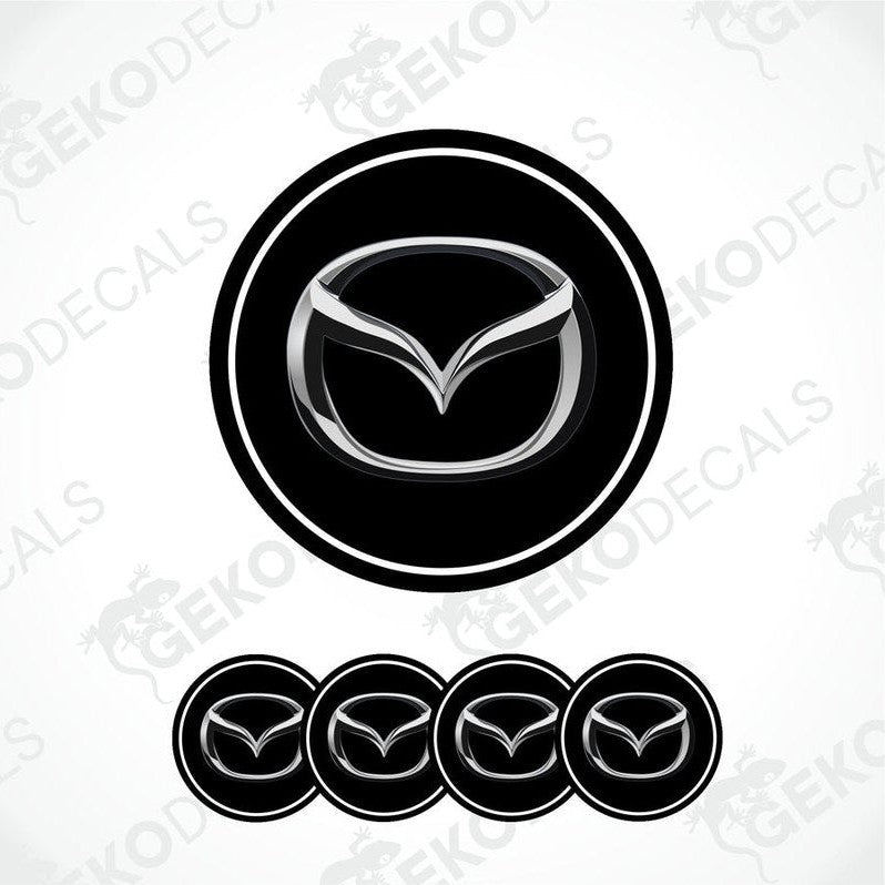 A set of four black vinyl stickers with a silver Mazda logo on each.