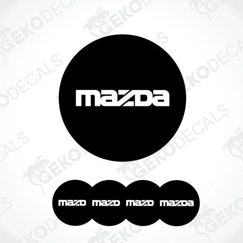 A set of four black vinyl stickers with the Mazda logo on them.