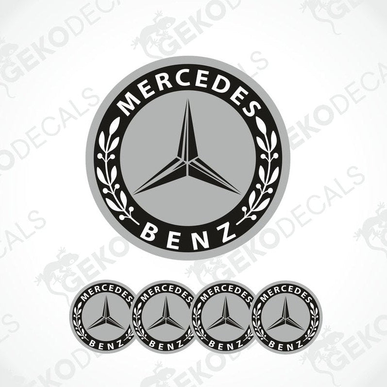 A set of four black and grey Mercedes-Benz wheel decals with a star logo in the center.