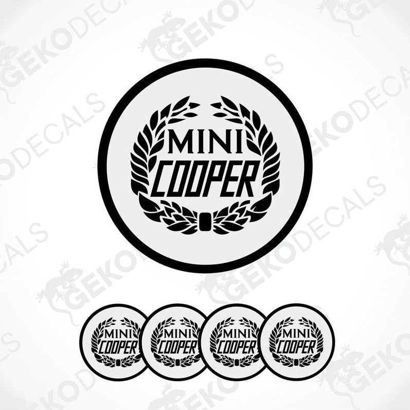 A set of four black and white vinyl decals with the text 'MINI COOPER' and a laurel wreath design.