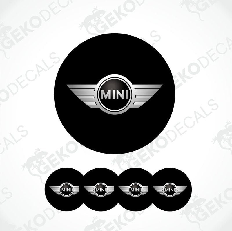 A set of four black vinyl stickers with the word 'MINI COOPR' in the center, designed to be applied on car wheels.