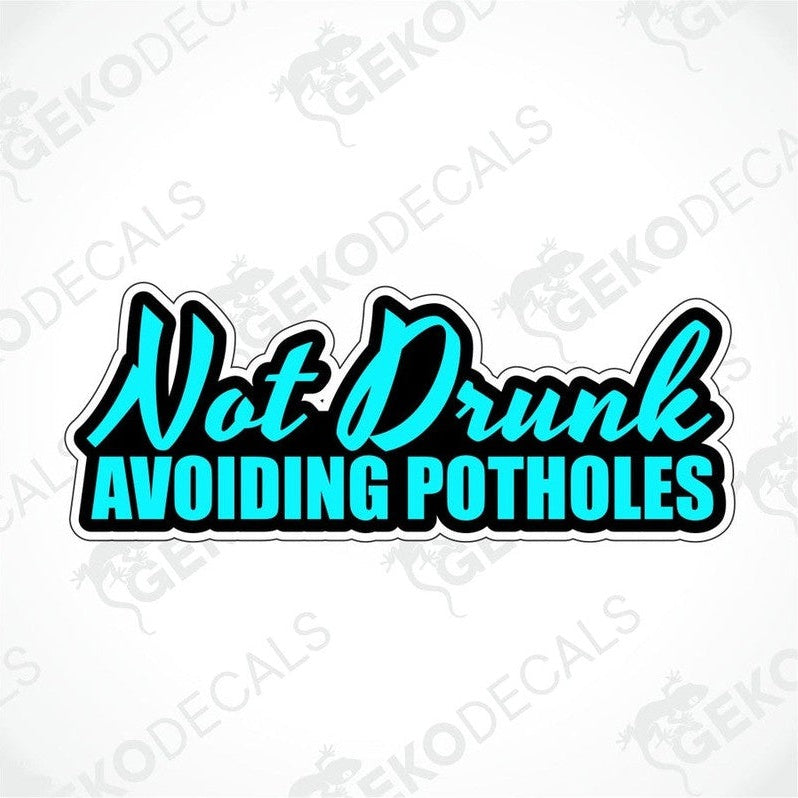 A car sticker with the text 'Not Drunk Avoiding Potholes' in blue on a white background.