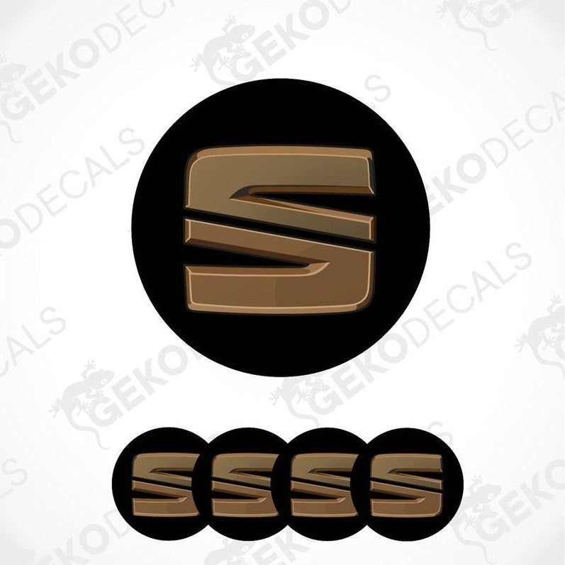 A set of four black and chrome brown vinyl stickers with the letter 'SEAT' in the center, designed for use as car decals.