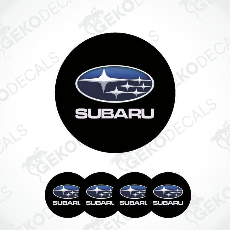 A set of four black vinyl stickers with the Subaru brand logo on them.