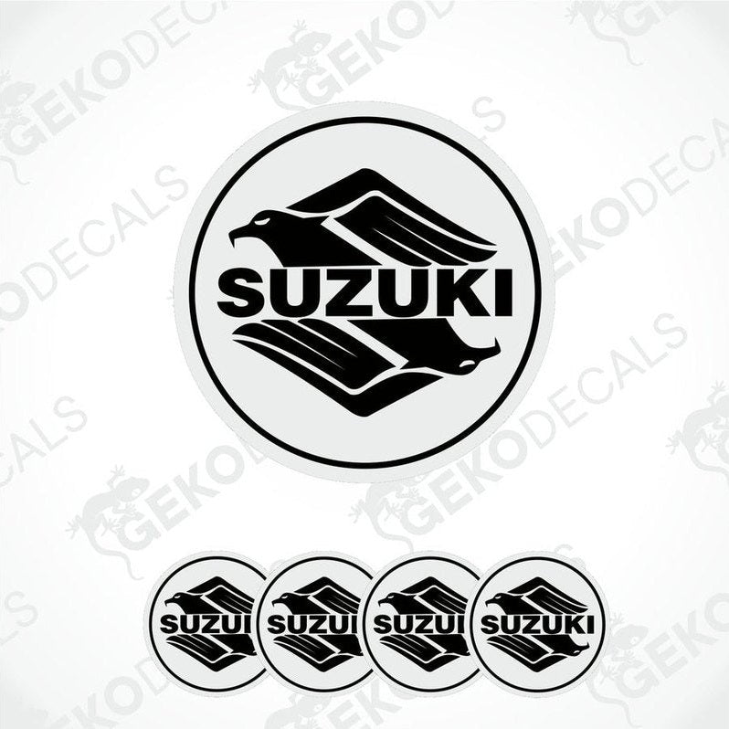 A set of four circular vinyl stickers with a Suzuki logo design, intended for use on vehicles.