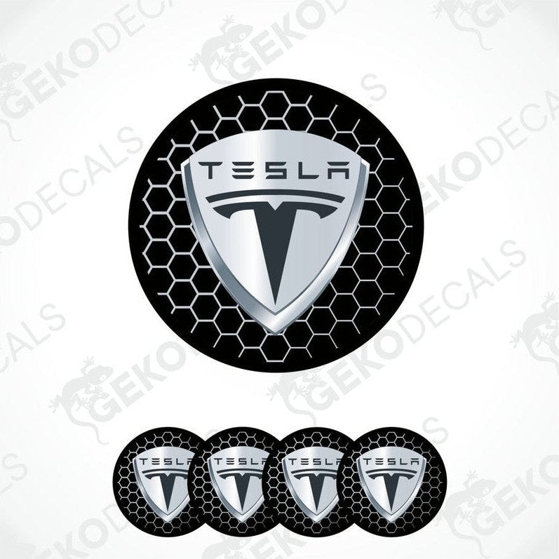 A set of four round Tesla branded vinyl stickers with a geometric pattern in black, white, and gray colors.