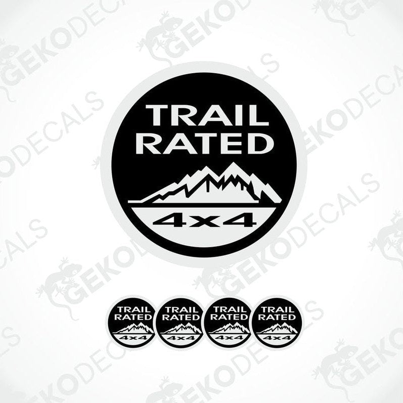 A set of four black and white vinyl stickers with the text 'TRAIL RATED 4X4' and a mountain range design.