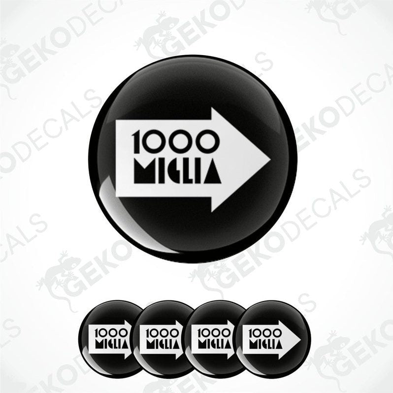 A set of four black and white vinyl decals with the text '1000 MIGLIA' on them, presented in a circular arrangement.