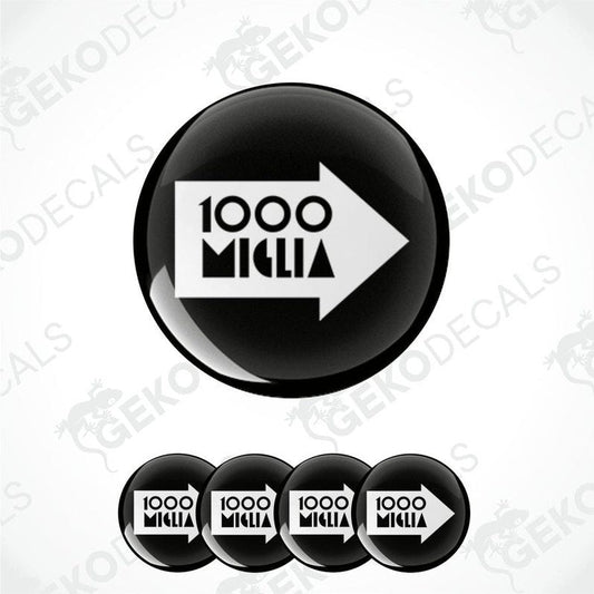 A set of four black and white vinyl decals with the text '1000 MIGLIA' on them, presented in a circular arrangement.