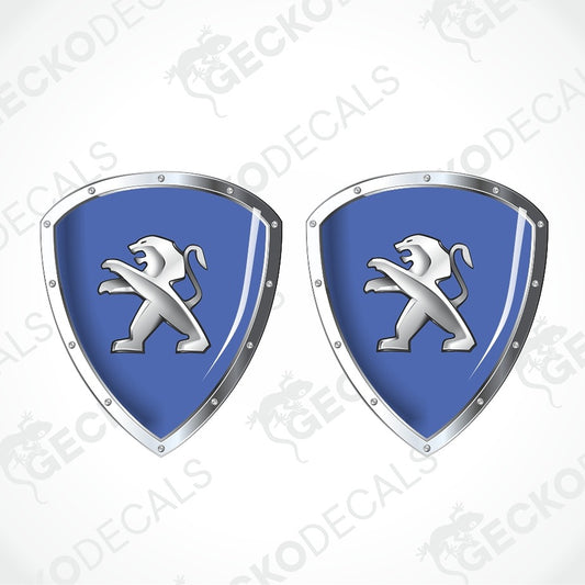 Two identical blue and silver shield-shaped decals with a white lion rampant emblem, shown on a light gray background with diagonal watermark text.