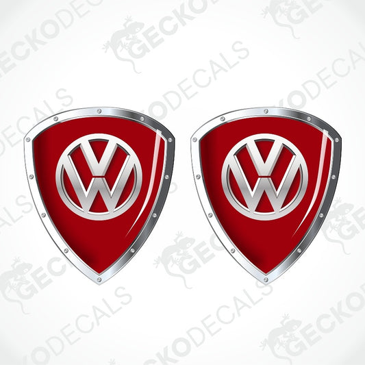 Two red and silver Volkswagen shield-shaped decals on a light gray background with faint Geekodec watermarks.