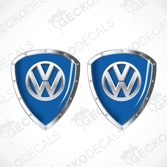 Two blue and silver Volkswagen shield-shaped decals on a light gray background with diagonal watermark text.