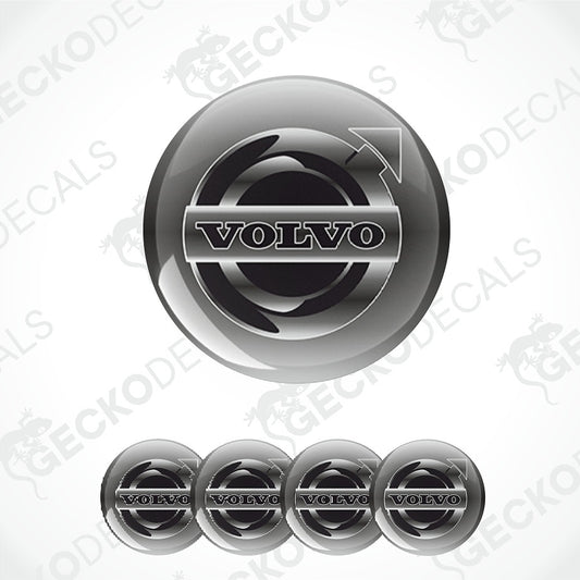 A glossy black and silver Volvo logo decal shown in a large circular format, with four smaller identical decals aligned along the bottom on a light gray background. Faint repeated 'GECKODE' watermarks are visible across the image.