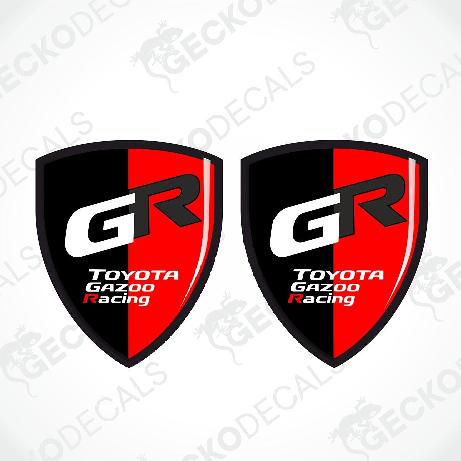 Two identical shield-shaped decals featuring the Toyota Gazoo Racing logo, with a black and red vertical split design and a large white 'GR' monogram.