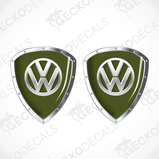 Two identical green and silver Volkswagen shield-shaped decals on a light gray background with diagonal watermark text.