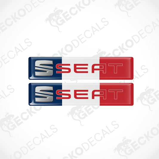 Two rectangular SEAT logo decals stacked vertically on a light gray background. Each decal has a blue, white, and red French flag design with the SEAT brand name and logo in silver and red.
