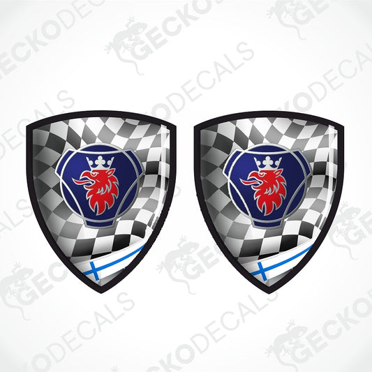 Two identical shield-shaped decals shown side by side on a light gray background. Each shield has a black-and-white checkered pattern, a blue center, a red lion emblem with a crown, and a small blue cross near the bottom.