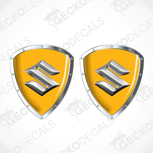 Two identical shield-shaped decals with a yellow center and a silver metallic stylized 'S' emblem, shown on a light gray background with diagonal watermark text.