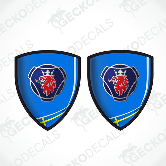 Two identical blue shield-shaped decals with a red lion rampant, a dark blue crest, a silver crown, and a yellow cross detail at the bottom, shown on a light gray background with diagonal watermarks.