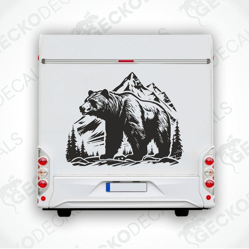 A black decal of a bear with mountains in the background, positioned on the side of a white vehicle.