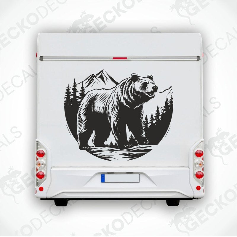 A decal featuring a black bear in a mountainous landscape with a white background, delivered on transfer paper.