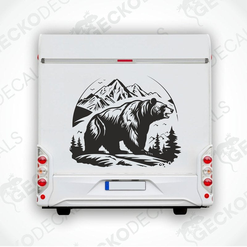 A decal featuring a black bear in a mountainous landscape with a white background, delivered on transfer paper.