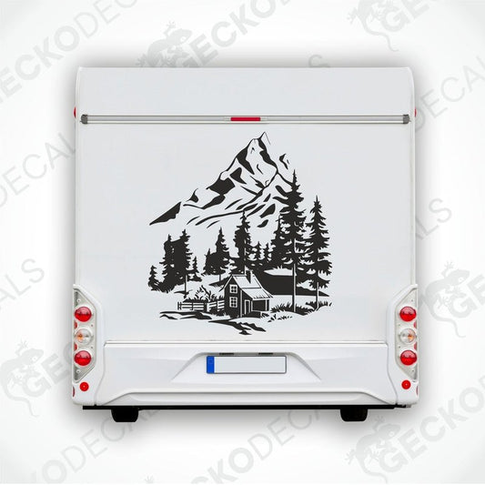 A black decal of a mountain house with trees in the foreground, placed on the rear of a white vehicle.