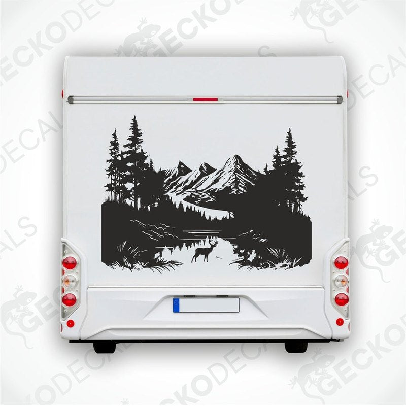 A decal of a lone deer in a mountain nature scene, displayed on the side of a white vehicle.