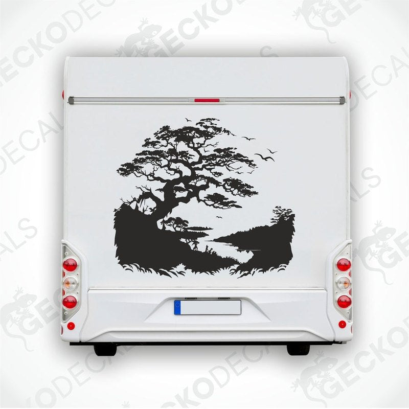 A black and white die cut sticker of a tree on the banks of a stream, applied to the side of a white car.