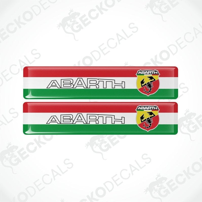 Two vinyl decals with a polyurethane coating featuring the Abarth logo and the colors red, white, and green.