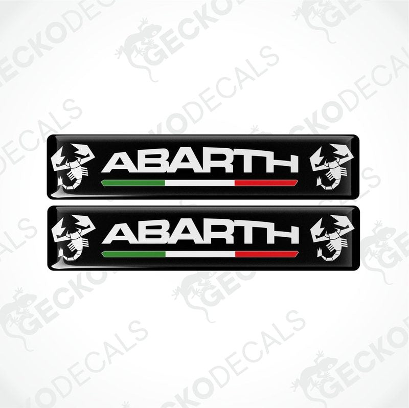 Two black vinyl decals with 'ABARTH' branding and Italian flag colors visible through the clear dome part.