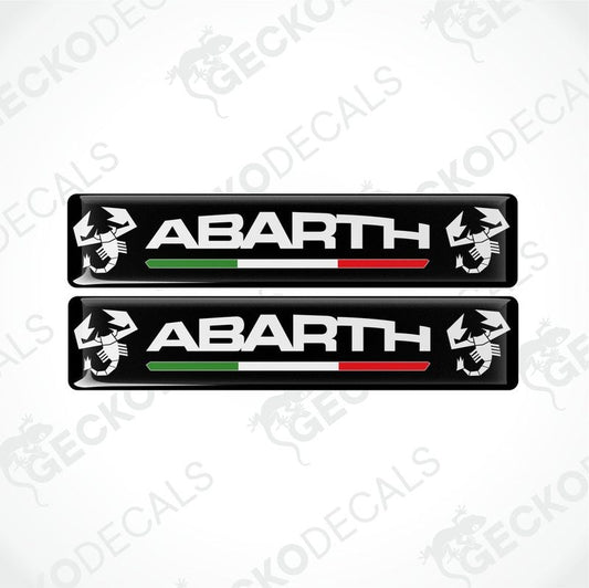 Two black vinyl decals with 'ABARTH' branding and Italian flag colors visible through the clear dome part.