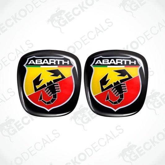 A set of two black, red, yellow, and green vinyl stickers with the 'ABARTH' logo on them.