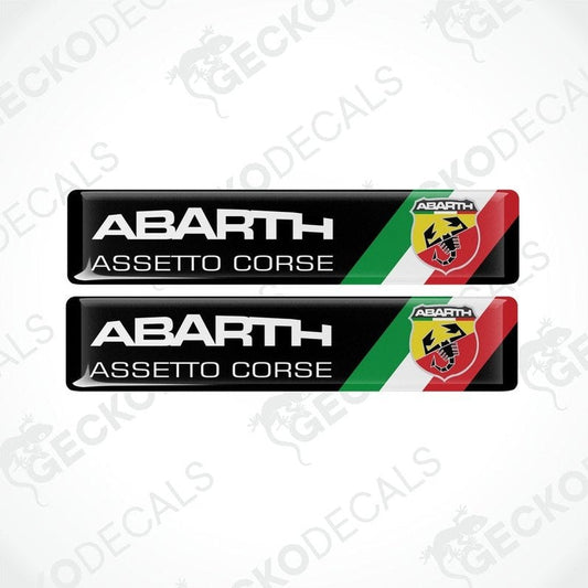 Two vinyl decals with 'ABARTH ASSETTO CORSE' text and Abarth logo in red, black, and white colors.