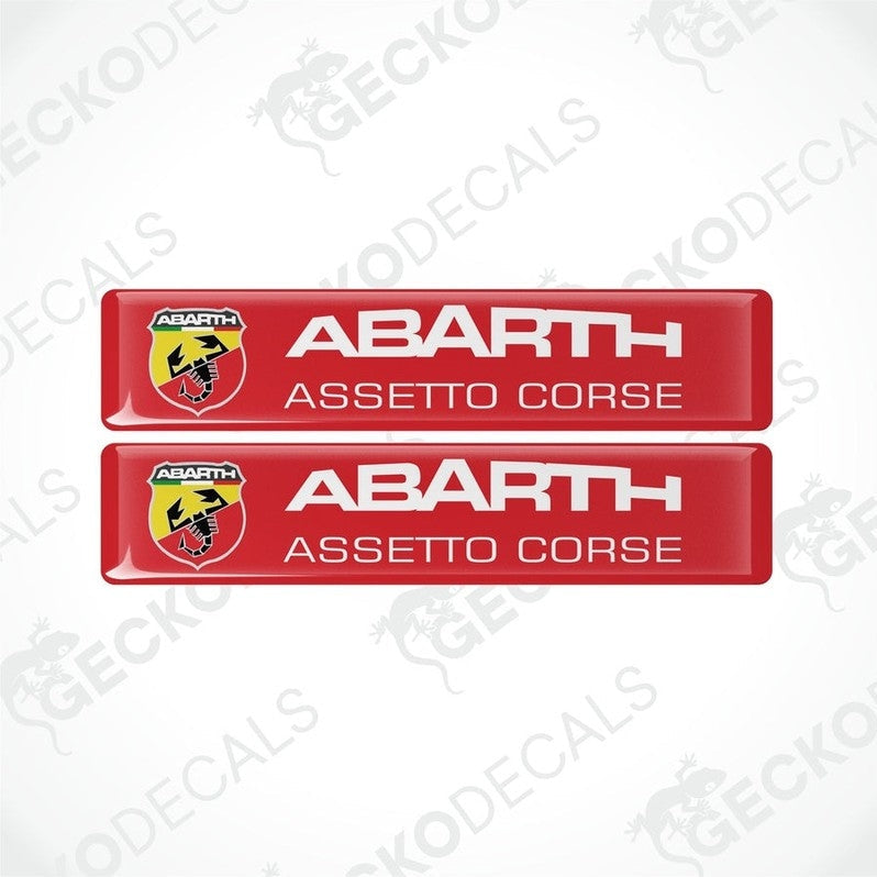 Two red rectangular vinyl decals with 'ABARTH ASSETTO CORSE' text and Abarth logo in white and yellow.