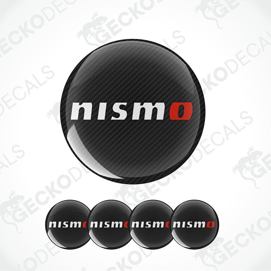 Four circular black carbon-fiber-texture decals with the white and red 'nismo' logo, shown on a white background with a large version above and four smaller versions below. Faint 'GECKODECALS' watermarks are visible across the image.