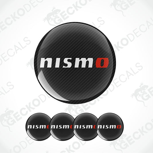 Four circular black carbon-fiber-texture decals with the white and red 'nismo' logo, shown on a white background with a large version above and four smaller versions below. Faint 'GECKODECALS' watermarks are visible across the image.