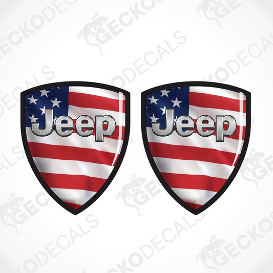 Two shield-shaped decals featuring the Jeep logo in silver over an American flag design with red and white stripes and a blue field with white stars, shown on a light gray background with a faint Geekodec watermark.