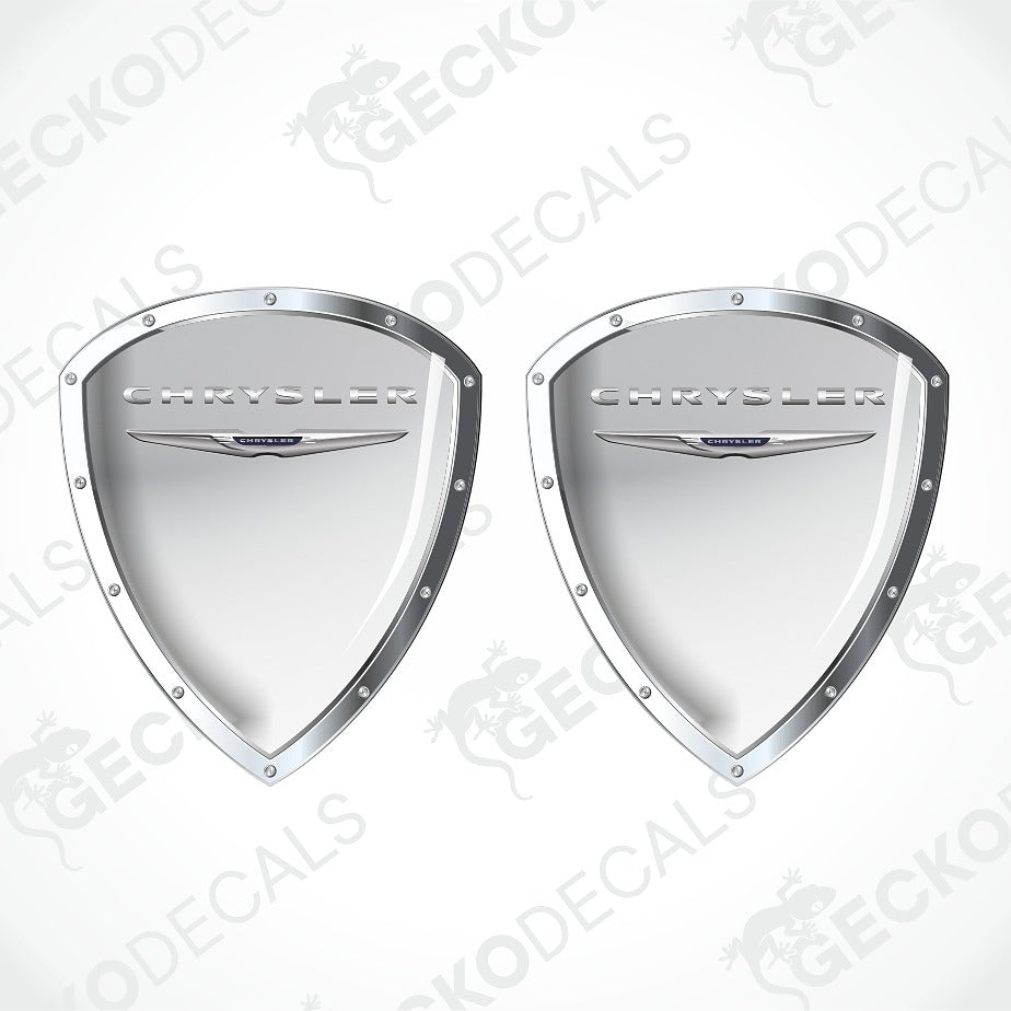 A pair of silver metallic shield-shaped Chrysler decal stickers on a white background with diagonal watermarks.