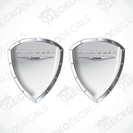 A pair of silver metallic shield-shaped Chrysler decal stickers on a white background with diagonal watermarks.