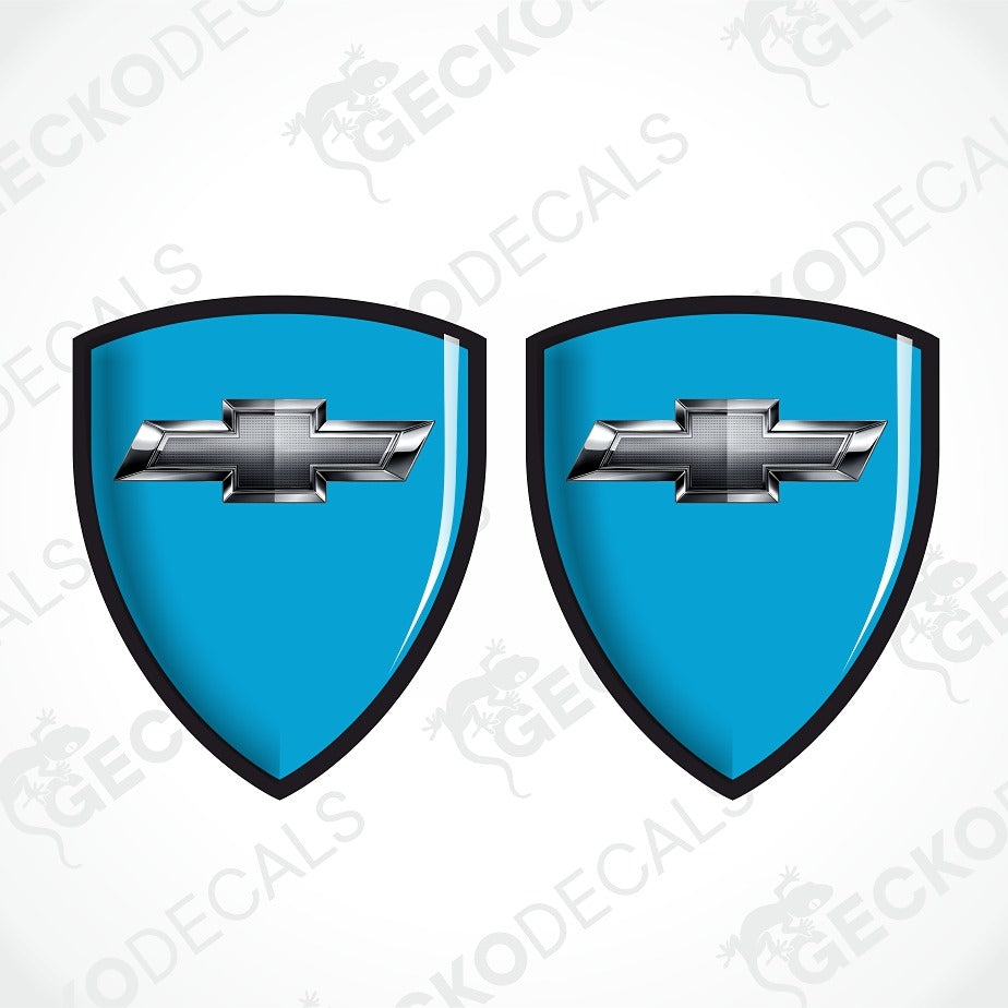 Two identical blue shield-shaped decal designs with black borders and a silver Chevrolet bowtie emblem in the center, shown on a white background with repeated GECKODECAL watermarks.