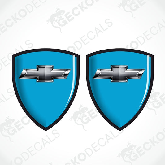 Two identical blue shield-shaped decal designs with black borders and a silver Chevrolet bowtie emblem in the center, shown on a white background with repeated GECKODECAL watermarks.