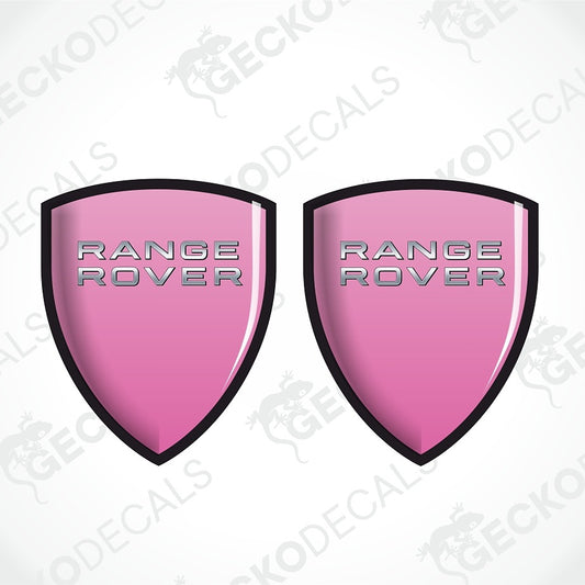 Two pink shield-shaped Range Rover decal stickers with silver lettering and black borders, shown on a white background with a faint watermark pattern.