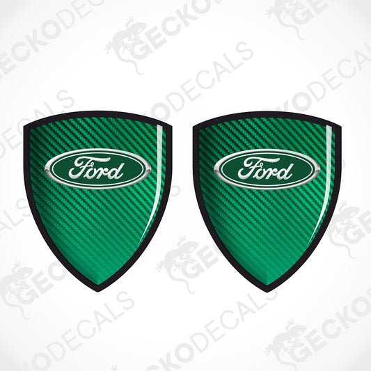 Two green shield-shaped decals with a carbon fiber texture and the Ford logo in the center, shown on a white background with diagonal watermarks.