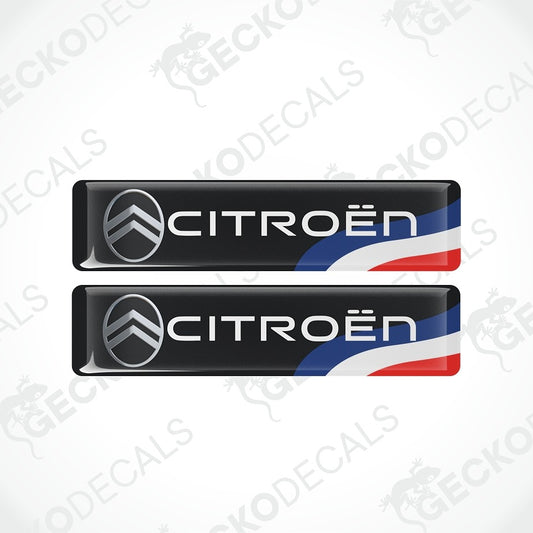 Two black Citroøn door sill decals with the brand's chevron logo and white 'CITROËN' lettering, shown on a light gray background with a faint watermark pattern.