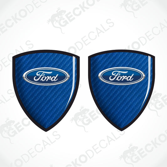 Two blue Ford shield-shaped decal stickers with a carbon fiber texture and the classic Ford oval logo in the center, displayed on a white background with diagonal watermarks.